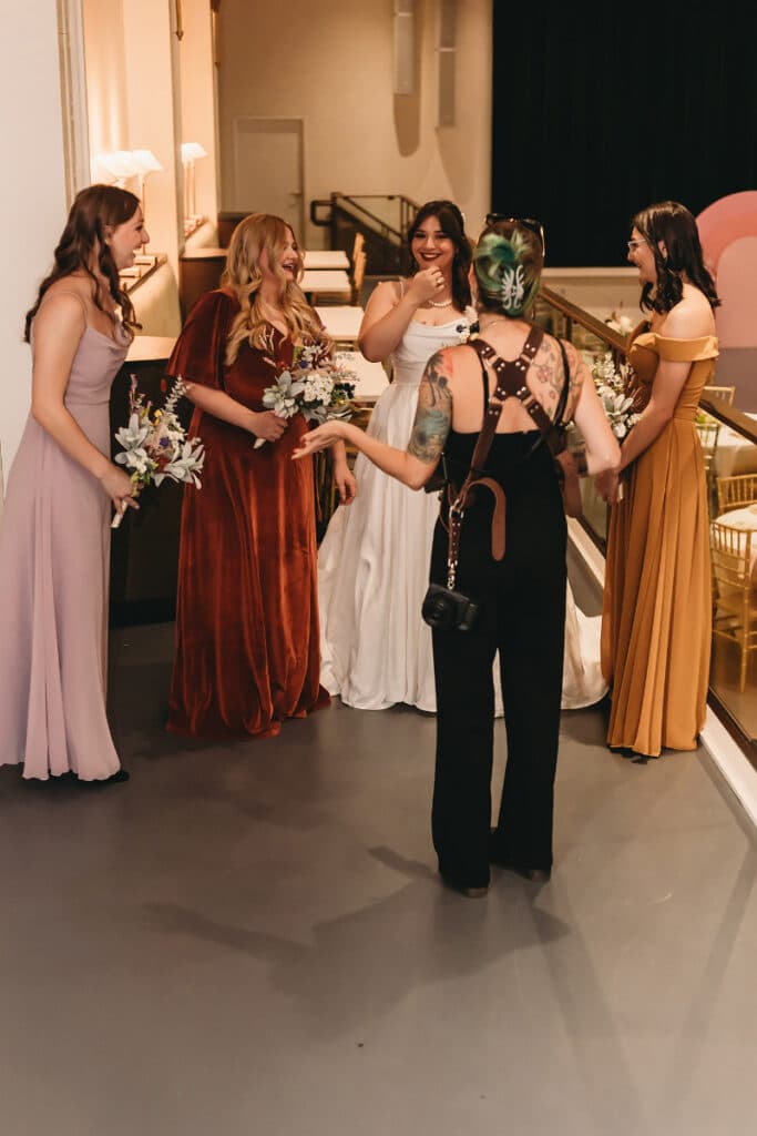 Bridal party laughter captured by wedding photography and videography.