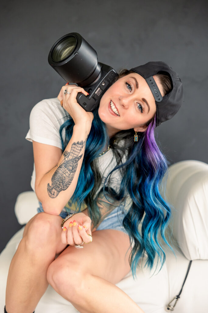 Branding photography featuring a confident woman posing in a director’s chair during an Oklahoma photography session.