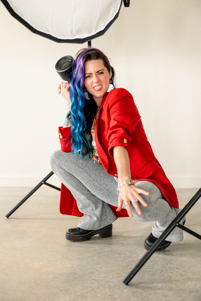 Professional photographer Ashley St. Clair posing with her camera during a creative branding photography session in Oklahoma.